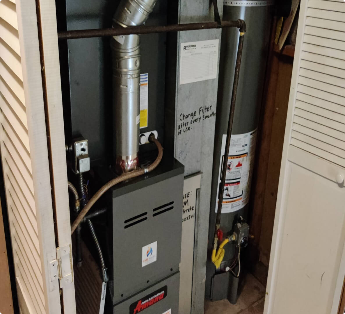 Residential HVAC furnace in a utility closet.