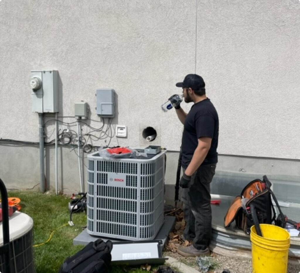 Technician servicing outdoor HVAC unit