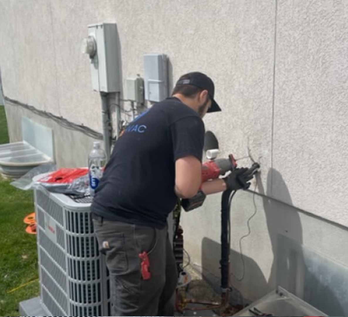 Technician servicing outdoor HVAC unit