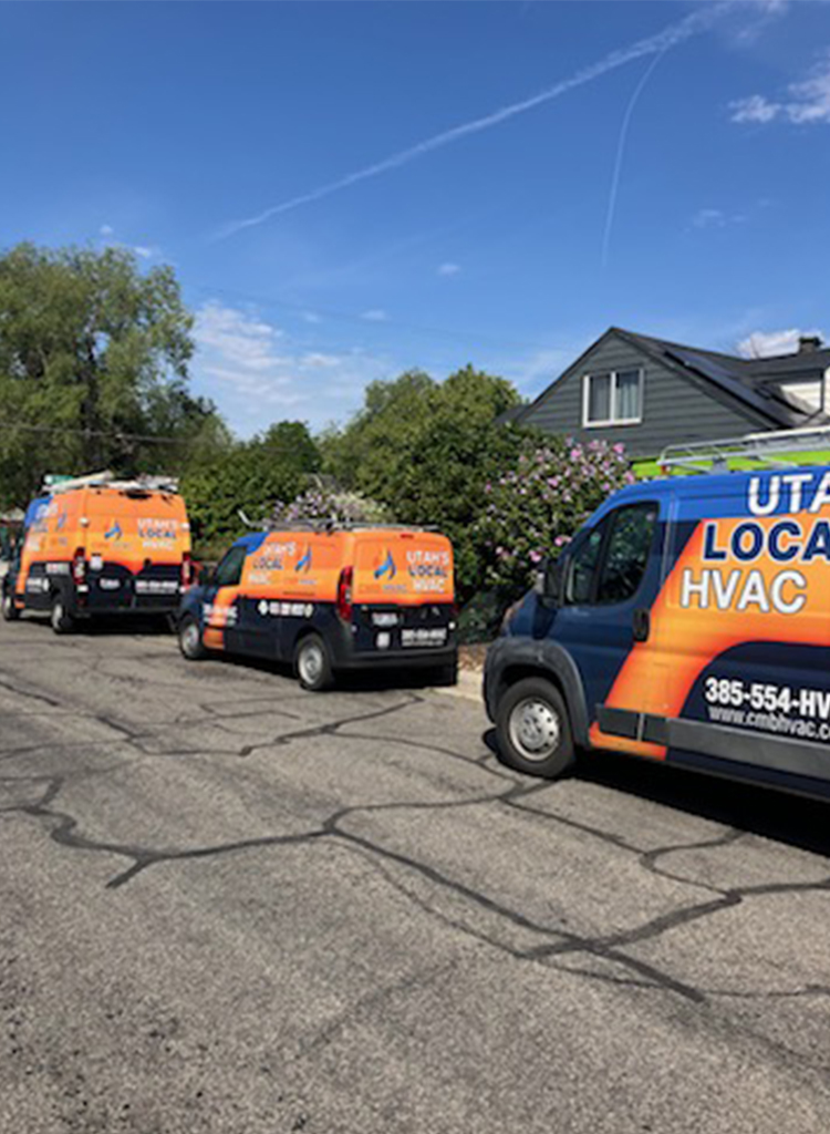 HVAC service vans parked outside a residential building.